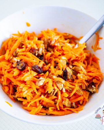 A white bowl with carrot salad