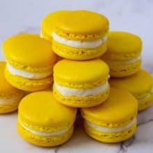 Stack of yellow lemon macarons on the plate.