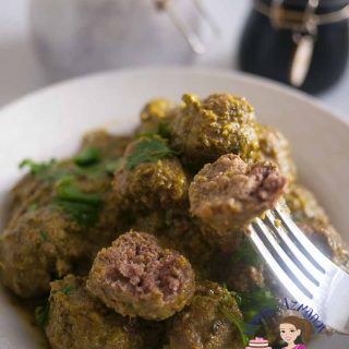 A bowl of meatballs with cilantro.