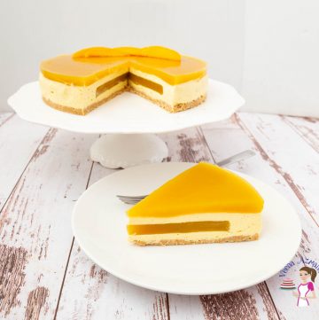 A slice of mango mousse cake on a plate.