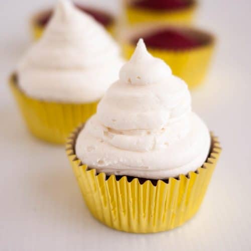 A cupcake with white frosting.