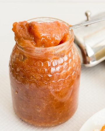 A jam jar with spoon.