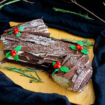 Christmas log cake on a wooden board.