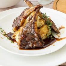 Lamb Chops over mashed potatoes served with balsamic sauce.