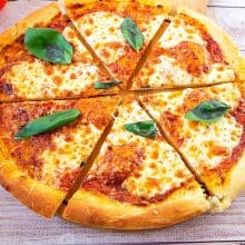 A sliced pizza on the table.