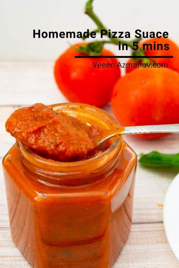 A jar of pizza sauce, with a spoon on top of it.