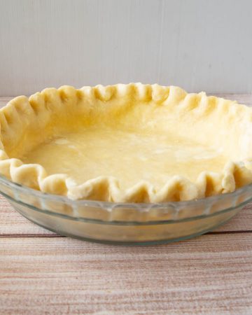 A crimped pie crust ready to be baked