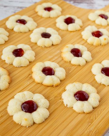 A wooden board with jam cookies