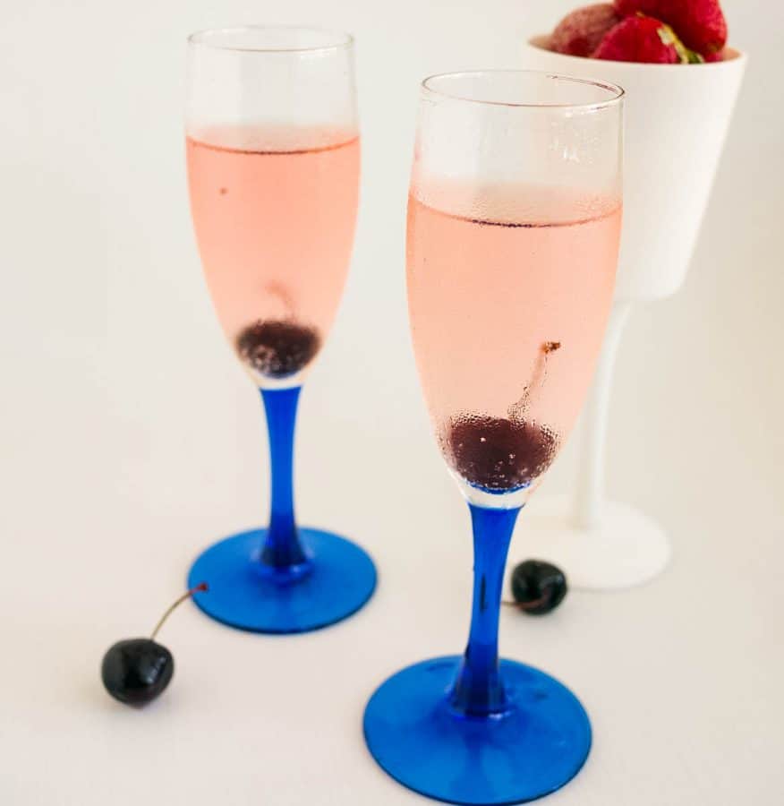 Two champagne glasses with champagne cocktail