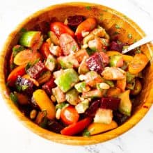 A wooden bowl with beet salad and lemon dressing.