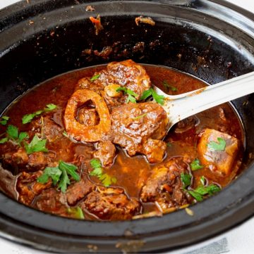 A slow cooker with veal shanks.