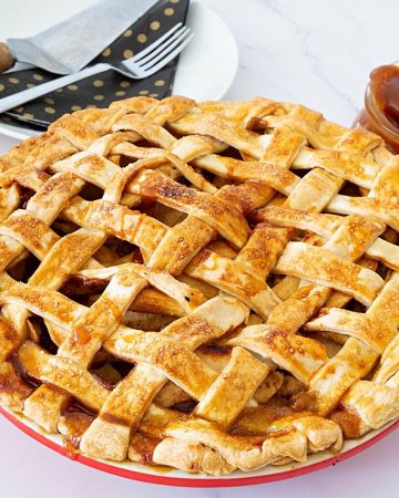 A lattice top apple pie in a pie pan.