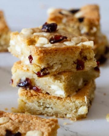 A stack of white chocolate cranberry bars on a table.