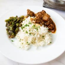 A plate with steamed rice and curry.